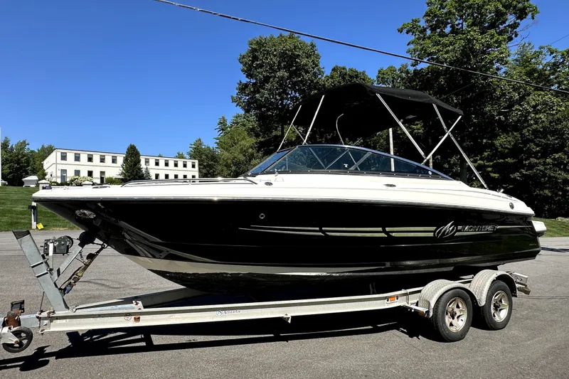 Slide: The Image of 2007 Monterey 234FSX boat on trailer, black and white design, parked outdoors. - 1