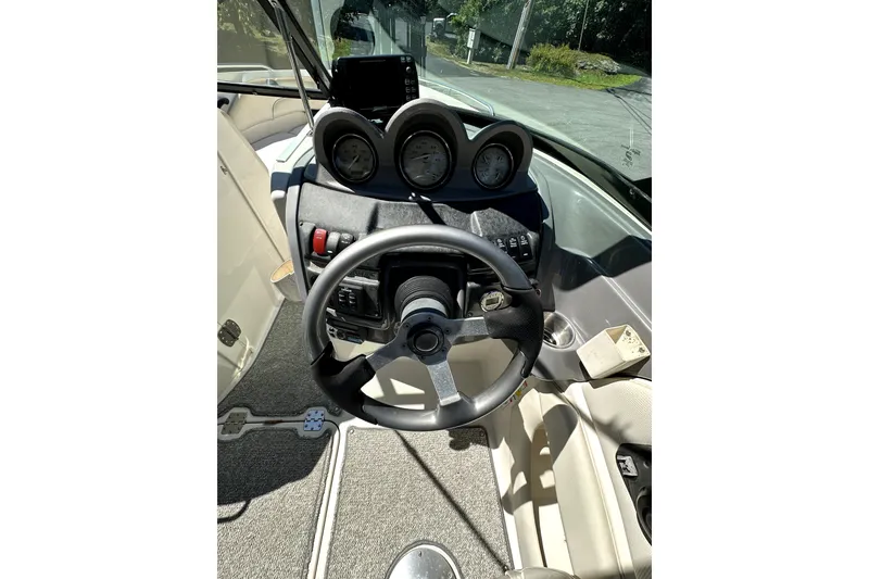 Slide: The Image of Steering console of a 2007 Monterey 234FSX boat with gauges and controls. - 9