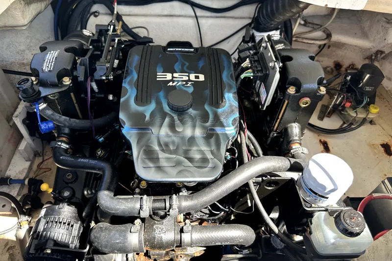 Slide: The Image of Engine compartment of a 2007 Monterey 234FSX boat featuring a 350 MPI engine. - 13