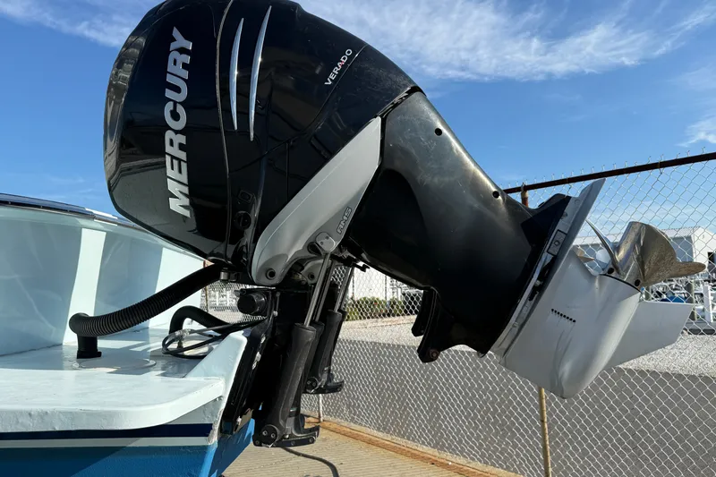 Slide: The Image of 2007 Outerbanks Express boat with Mercury Verado outboard motor, docked under clear sky. - 34