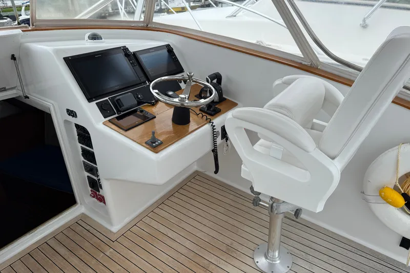 Slide: The Image of Helm of 2007 Outerbanks Express boat with steering wheel and navigation screens. - 18