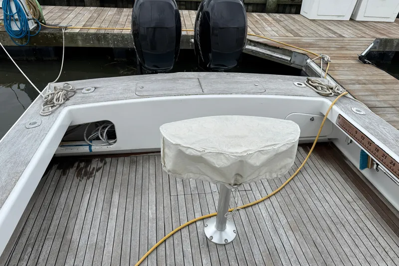 Slide: The Image of 2007 Outerbanks Express boat deck with covered pedestal and dual engines at dock. - 21
