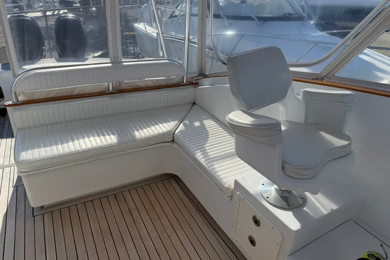 Slide: The Image of 2007 Custom Carolina Express boat interior with white seating and wooden flooring. - 20