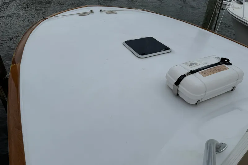 Slide: The Image of 2007 Outerbanks Express boat deck with hatch and secured white container. - 23