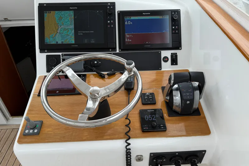Slide: The Image of Steering console of a 2007 Outerbanks Express boat with navigation screens and controls. - 7