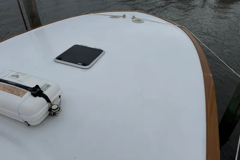 Slide: The Image of 2007 Outerbanks Express boat deck with hatch and safety equipment by the water. - 25