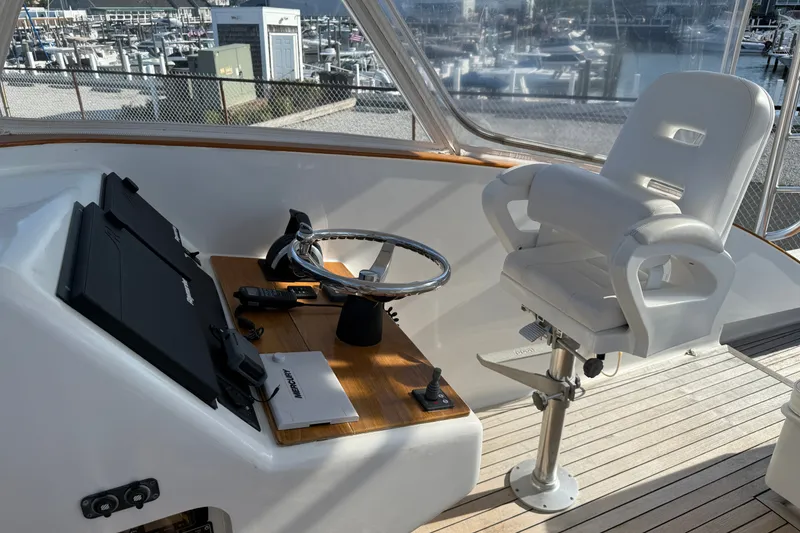 Slide: The Image of 2007 Custom Carolina Express boat helm with steering wheel, controls, and captain's chair. - 19
