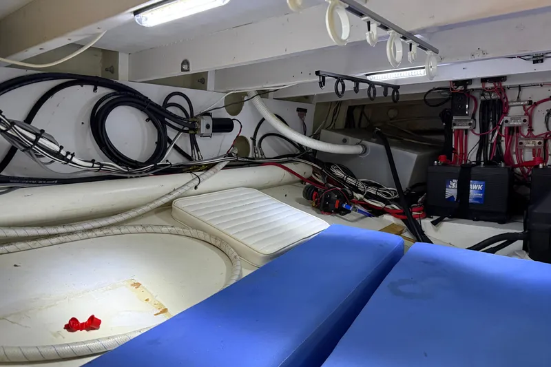 Slide: The Image of Engine room of a 2007 Outerbanks Express boat, featuring wiring and battery setup. - 30