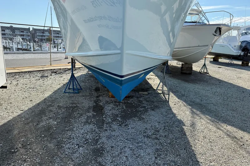 Slide: The Image of 2007 Outerbanks Express boat on stands in a marina, side view. - 3