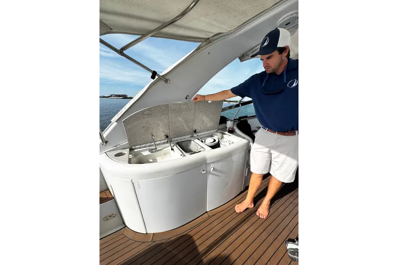 Slide: The Image of Man demonstrating kitchen area on 2004 Formula 370 Super Sport boat. - 22