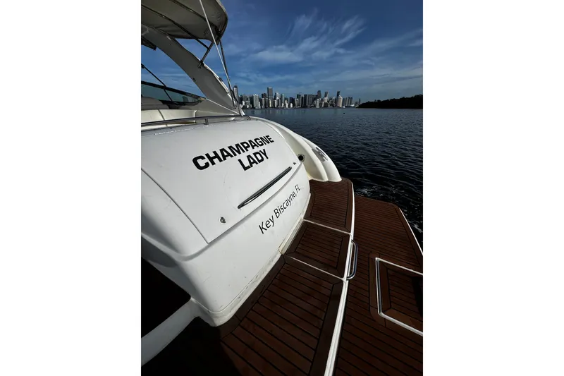 Slide: The Image of 2004 Formula 370 Super Sport yacht "Champagne Lady" on water near city skyline. - 14