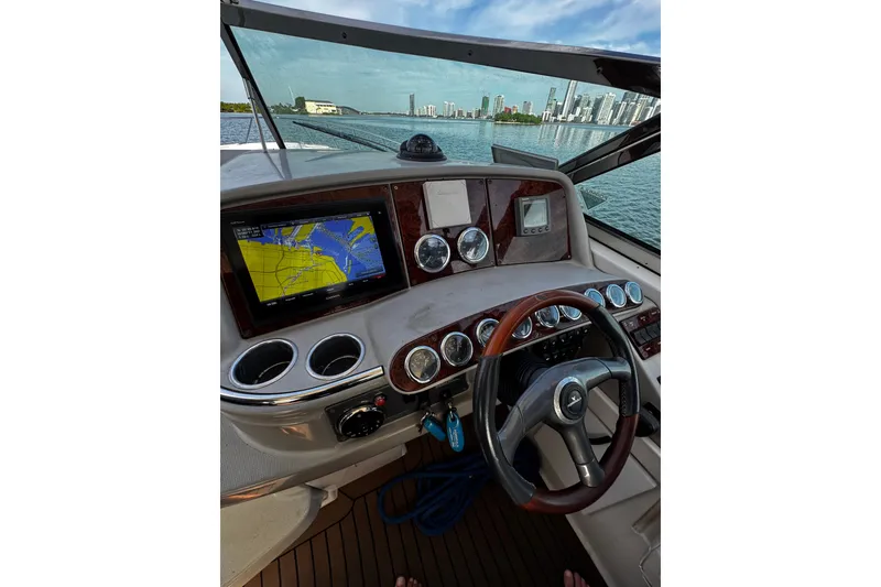 Slide: The Image of Cockpit view of 2004 Formula 370 Super Sport boat with navigation display and city skyline. - 21