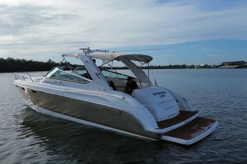Slide: The Image of 2004 Formula 370 Super Sport boat on calm water under a clear sky. - 13