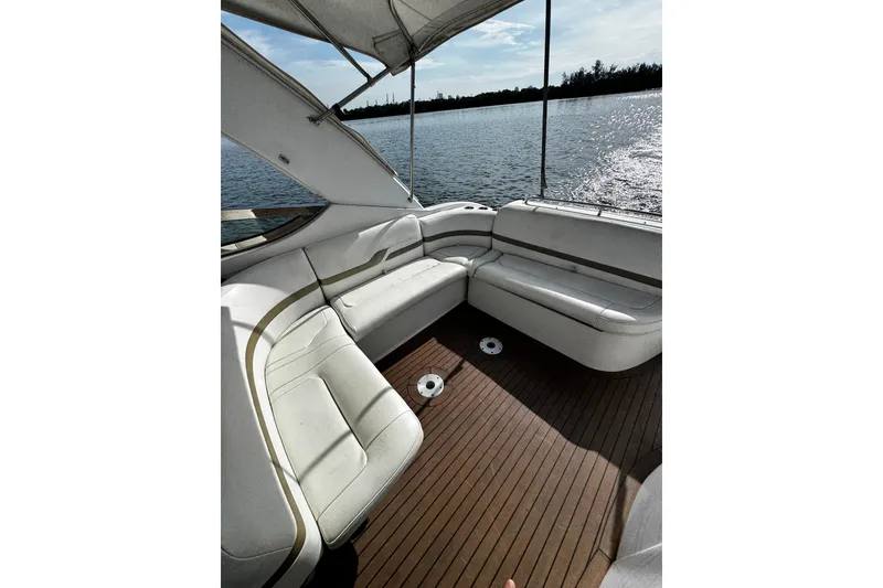 Slide: The Image of 2004 Formula 370 Super Sport boat interior with white seating and wooden deck. - 16