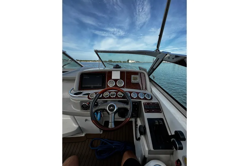 Slide: The Image of Cockpit view of a 2004 Formula 370 Super Sport boat on open water. - 23
