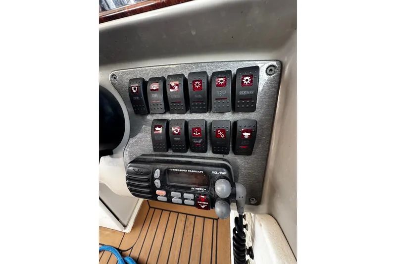 Slide: The Image of Control panel of a 2004 Formula 370 Super Sport boat with switches and radio. - 30