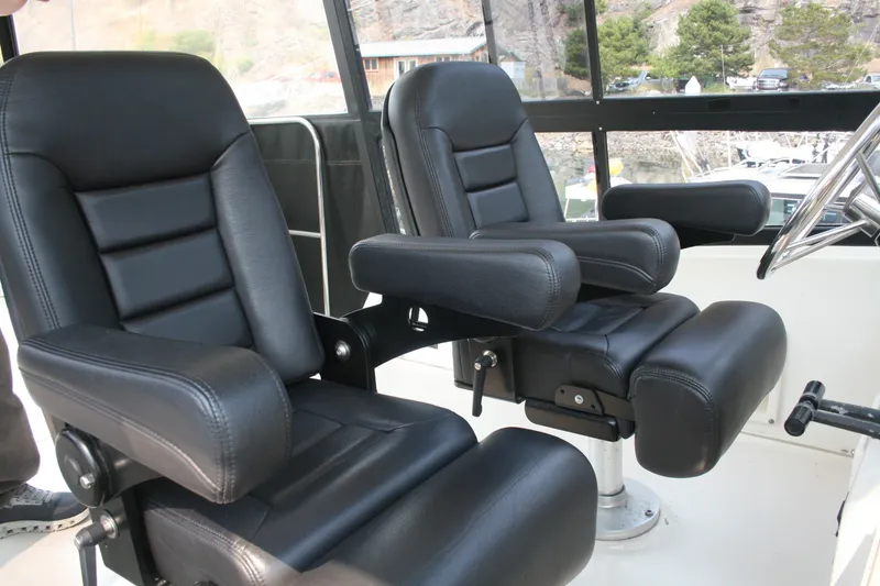 Slide: The Image of Black leather seats in the cockpit of a 1989 Silverton 34 Convertible boat. - 6