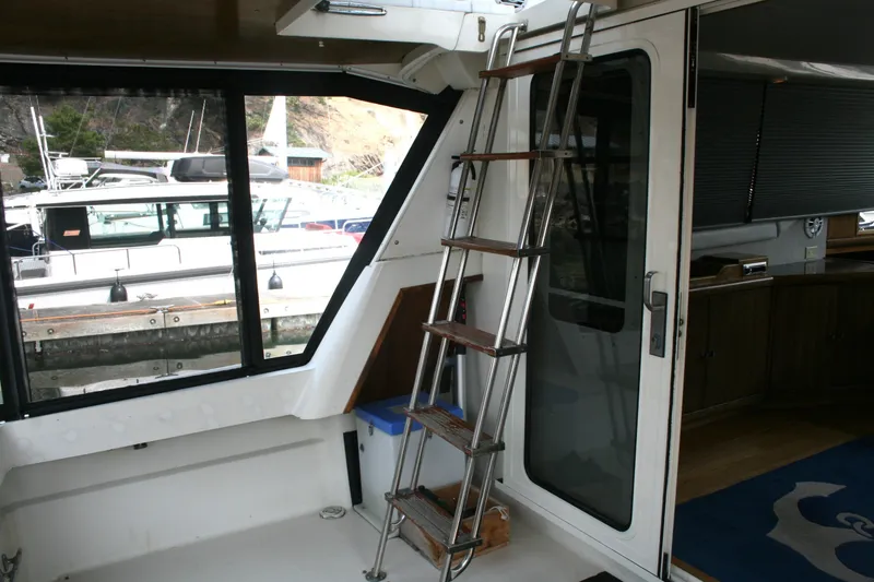 Slide: The Image of Interior view of 1989 Silverton 34 Convertible yacht with ladder and window. - 2