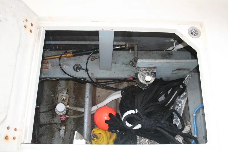 Slide: The Image of Storage compartment of a 1989 Silverton 34 Convertible boat with ropes and equipment. - 34