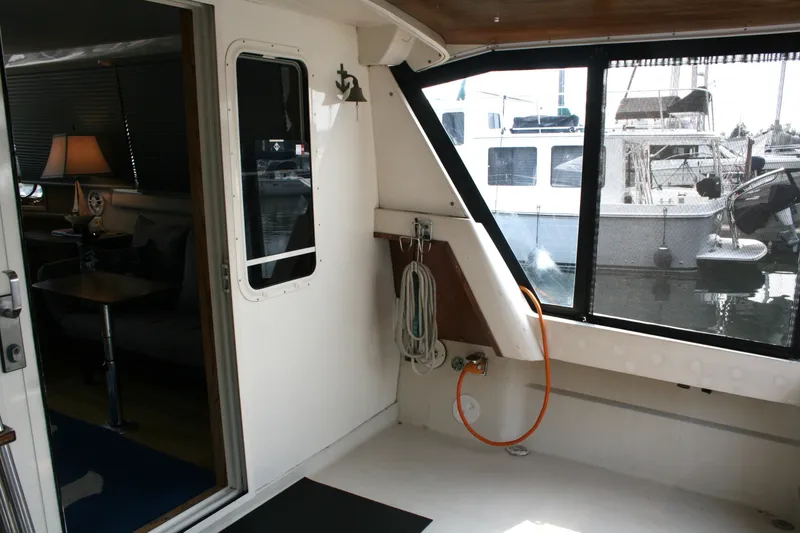 Slide: The Image of 1989 Silverton 34 Convertible yacht interior with marina view through windows. - 30