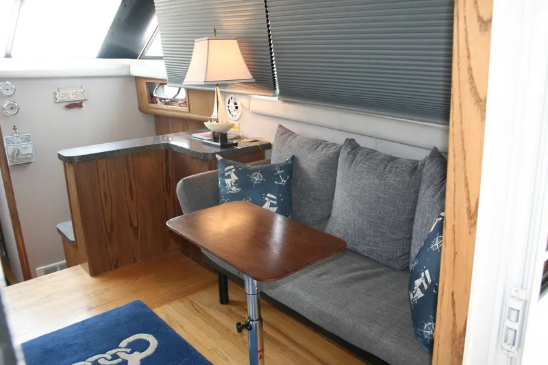 Slide: The Image of Interior of 1989 Silverton 34 Convertible yacht with cozy seating and nautical decor. - 12