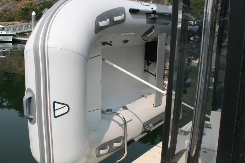 Slide: The Image of Inflatable dinghy attached to a 1989 Silverton 34 Convertible yacht at a marina. - 41