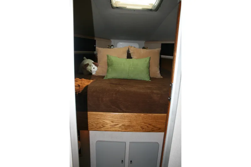 Slide: The Image of Cozy cabin interior of 1989 Silverton 34 Convertible with plush bedding and pillows. - 20