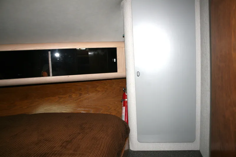 Slide: The Image of Interior cabin of 1989 Silverton 34 Convertible with bed, cabinet, and fire extinguisher. - 21