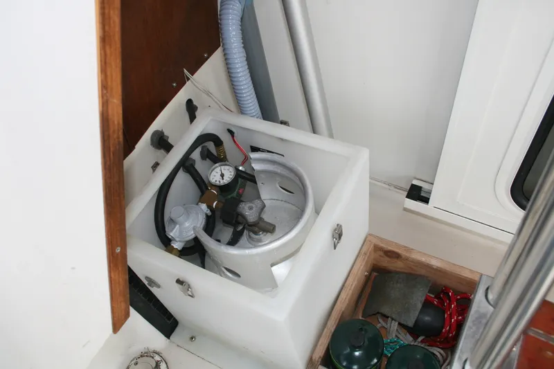 Slide: The Image of 1989 Silverton 34 Convertible boat interior showing propane tank and storage area. - 37