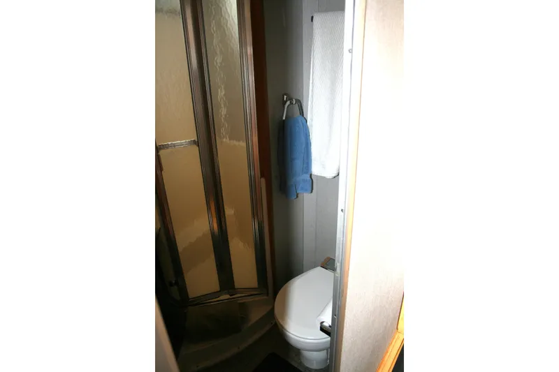 Slide: The Image of Compact bathroom in 1989 Silverton 34 Convertible yacht with shower and toilet. - 23