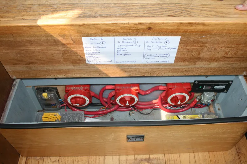 Slide: The Image of Electrical panel of a 1989 Silverton 34 Convertible boat with labeled switches and wiring. - 32
