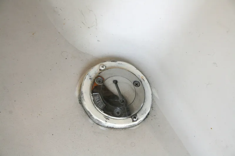 Slide: The Image of Close-up of a 1989 Silverton 34 Convertible boat's deck fitting with visible screws. - 39
