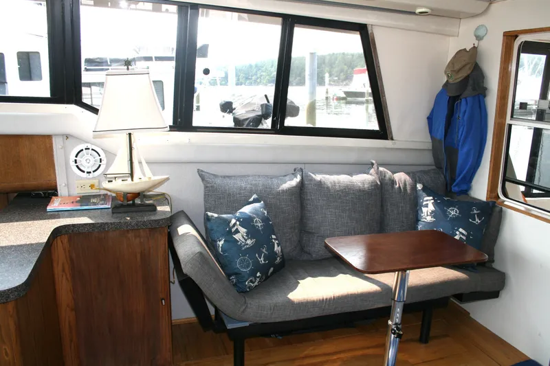 Slide: The Image of Interior of 1989 Silverton 34 Convertible with cozy seating and nautical decor. - 11