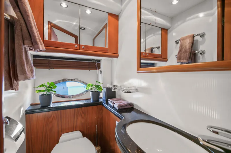 Slide: The Image of Luxurious bathroom interior of 2006 Sunseeker Predator 68 yacht with wood accents and porthole. - 23