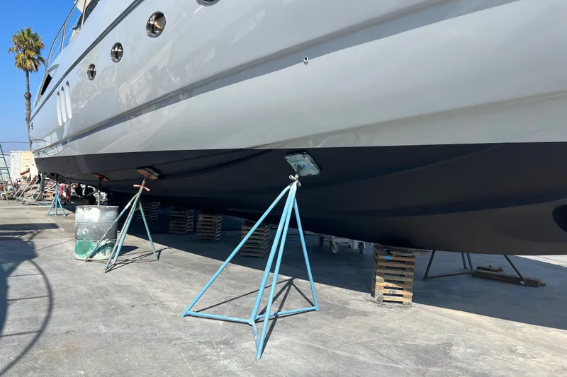 Slide: The Image of 2006 Sunseeker Predator 68 yacht on stands for maintenance in a shipyard. - 44