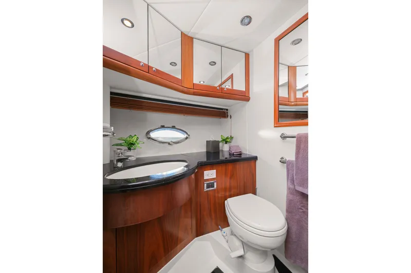 Slide: The Image of Luxurious bathroom in 2006 Sunseeker Predator 68 yacht with elegant wood cabinetry. - 26