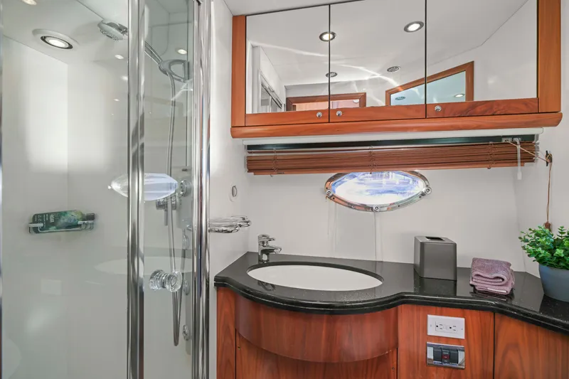 Slide: The Image of Luxurious bathroom in 2006 Sunseeker Predator 68 yacht with modern fixtures and elegant wood accents. - 38