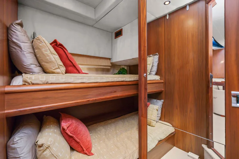 Slide: The Image of Luxurious 2006 Sunseeker Predator 68 yacht cabin with cozy bunk beds and elegant wood finish. - 28