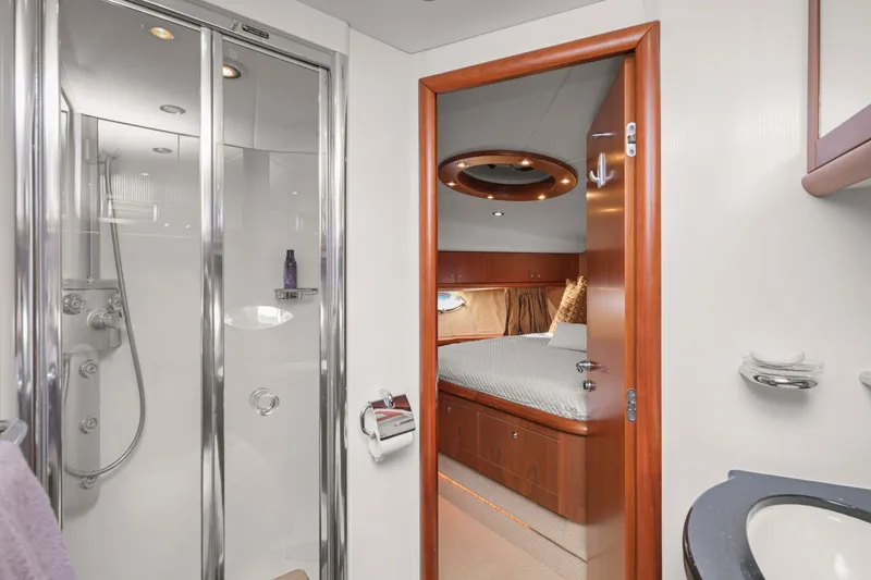 Slide: The Image of Luxurious interior of 2006 Sunseeker Predator 68 yacht featuring bedroom and bathroom. - 27