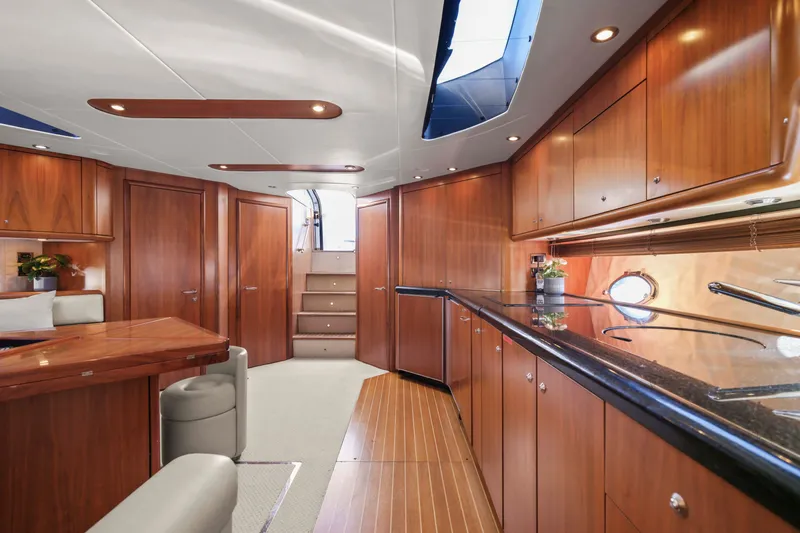 Slide: The Image of The interior cabin of the 2006 Sunseeker Predator 68 features elegant wood finishes and modern amenities. - 17