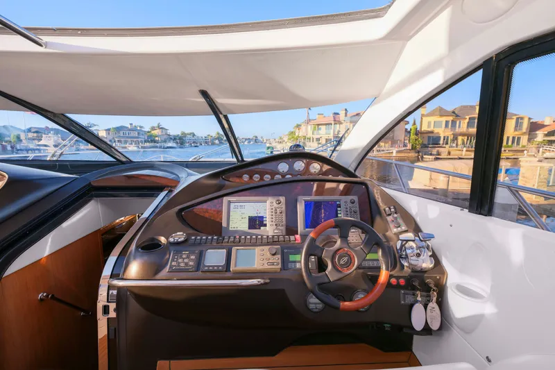 Slide: The Image of Cockpit of 2006 Sunseeker Predator 68 yacht with advanced navigation controls and waterfront view. - 14