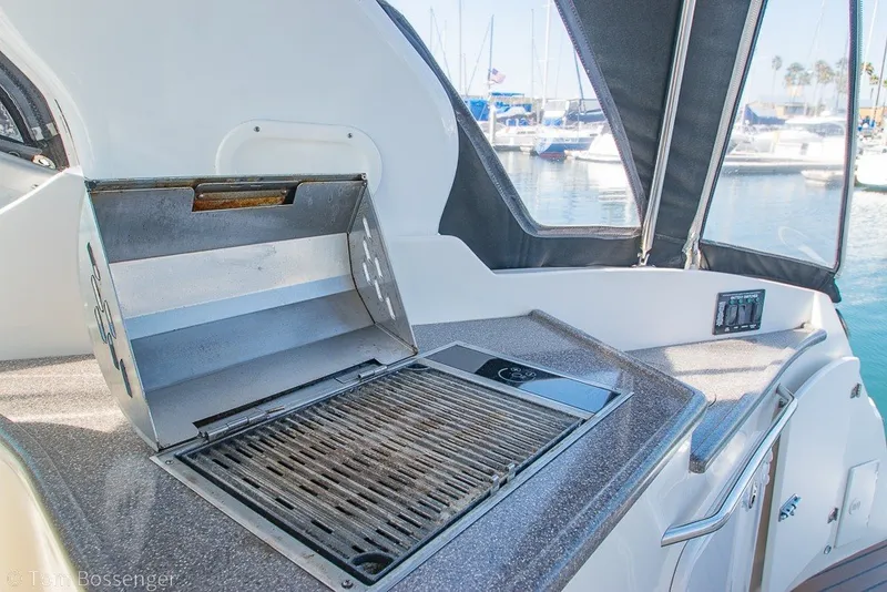 Slide: The Image of Outdoor grill on 2012 Rinker 310 Express Cruiser yacht, docked at marina. - 39