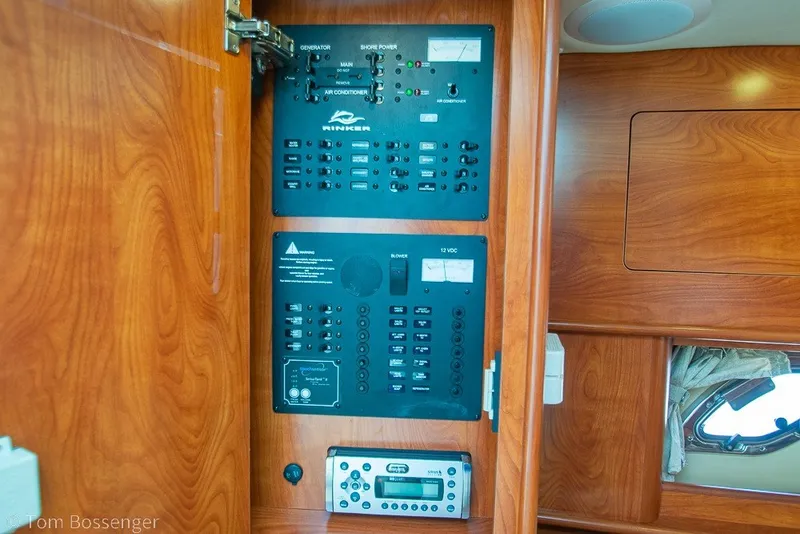 Slide: The Image of Control panel inside 2012 Rinker 310 Express Cruiser, featuring generator and shore power switches. - 22