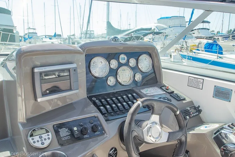 Slide: The Image of 2012 Rinker 310 Express Cruiser helm with gauges and navigation equipment. - 34