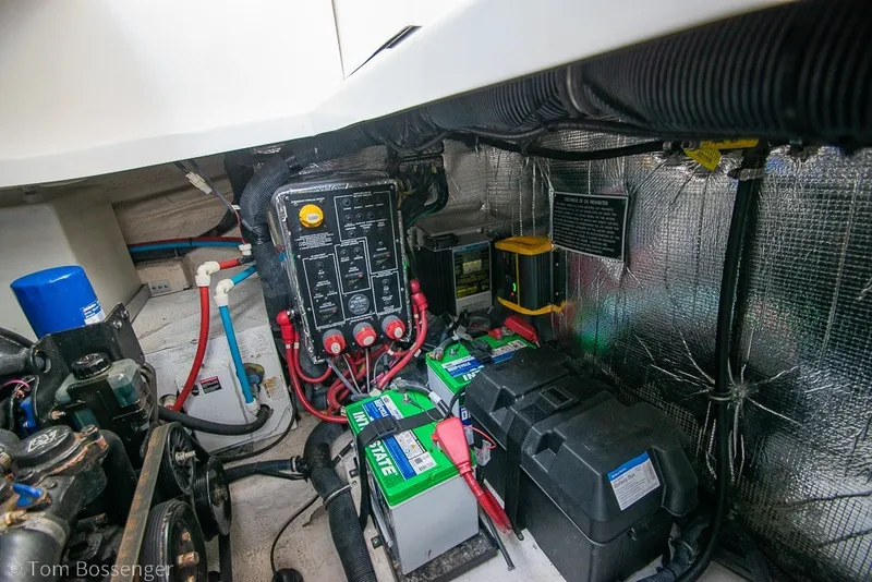 Slide: The Image of Engine compartment of a 2012 Rinker 310 Express Cruiser with batteries and wiring. - 11
