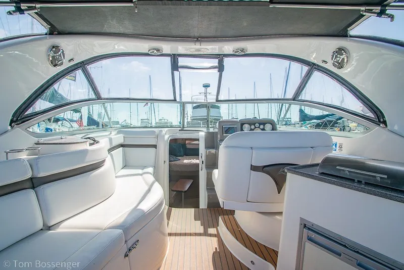 Slide: The Image of Interior of 2012 Rinker 310 Express Cruiser with luxurious seating and helm. - 29