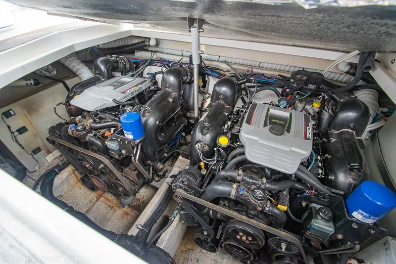Slide: The Image of Engine compartment of a 2012 Rinker 310 Express Cruiser with dual inboard motors. - 9