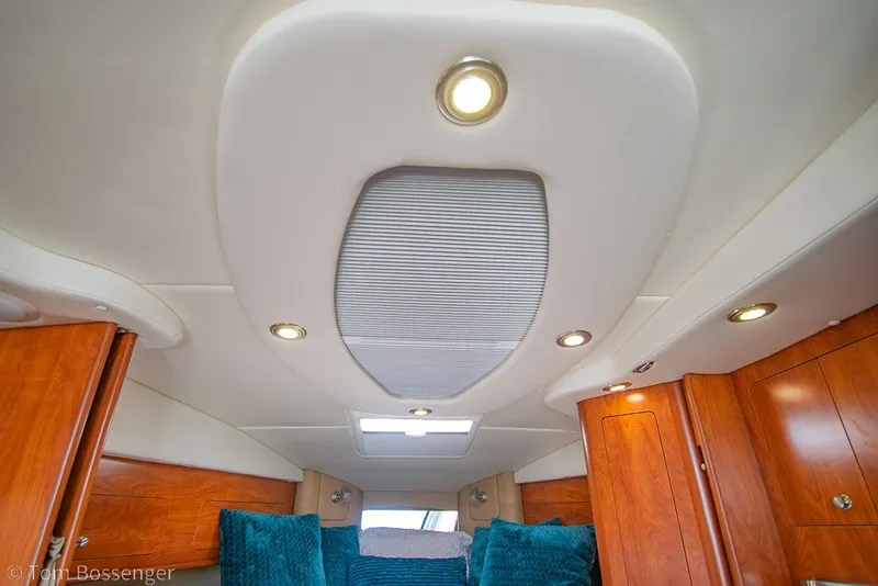 Slide: The Image of Interior cabin of 2012 Rinker 310 Express Cruiser with wood paneling and recessed lighting. - 26