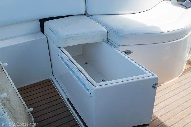 Slide: The Image of Rinker 310 Express Cruiser 2012 boat interior with open storage compartment. - 12