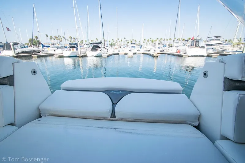 Slide: The Image of 2012 Rinker 310 Express Cruiser at marina with sailboats in background. - 42